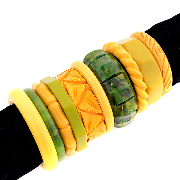 Collection of Ten Bakelite Bangles.   Including green and yellow carved, geometric and simple