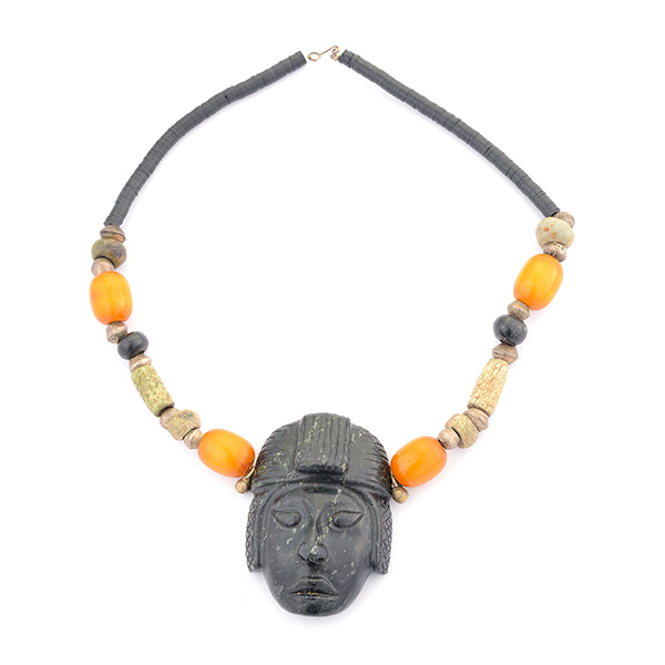 Jade, Plastic, Metal Necklace. Centering one carved jade face measuring approximately 75 x 50 mm,