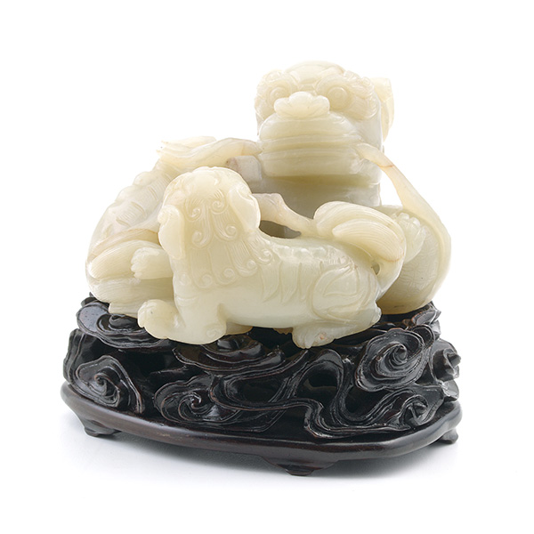 A Jade Buddhist Lion Group Portraying an adult playfully contending for a ribbon or tuft of smoke