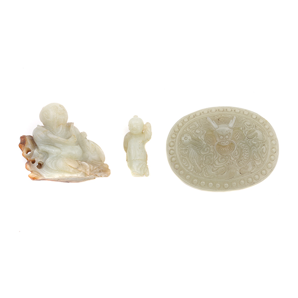 Three Jade Carvings The group comprises two figural carvings, one of a scholar reclining against a