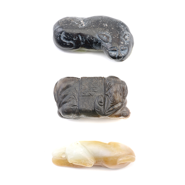Three Jade Animal Carvings The group comprises a recumbent dog, a recumbent lion and a recumbent