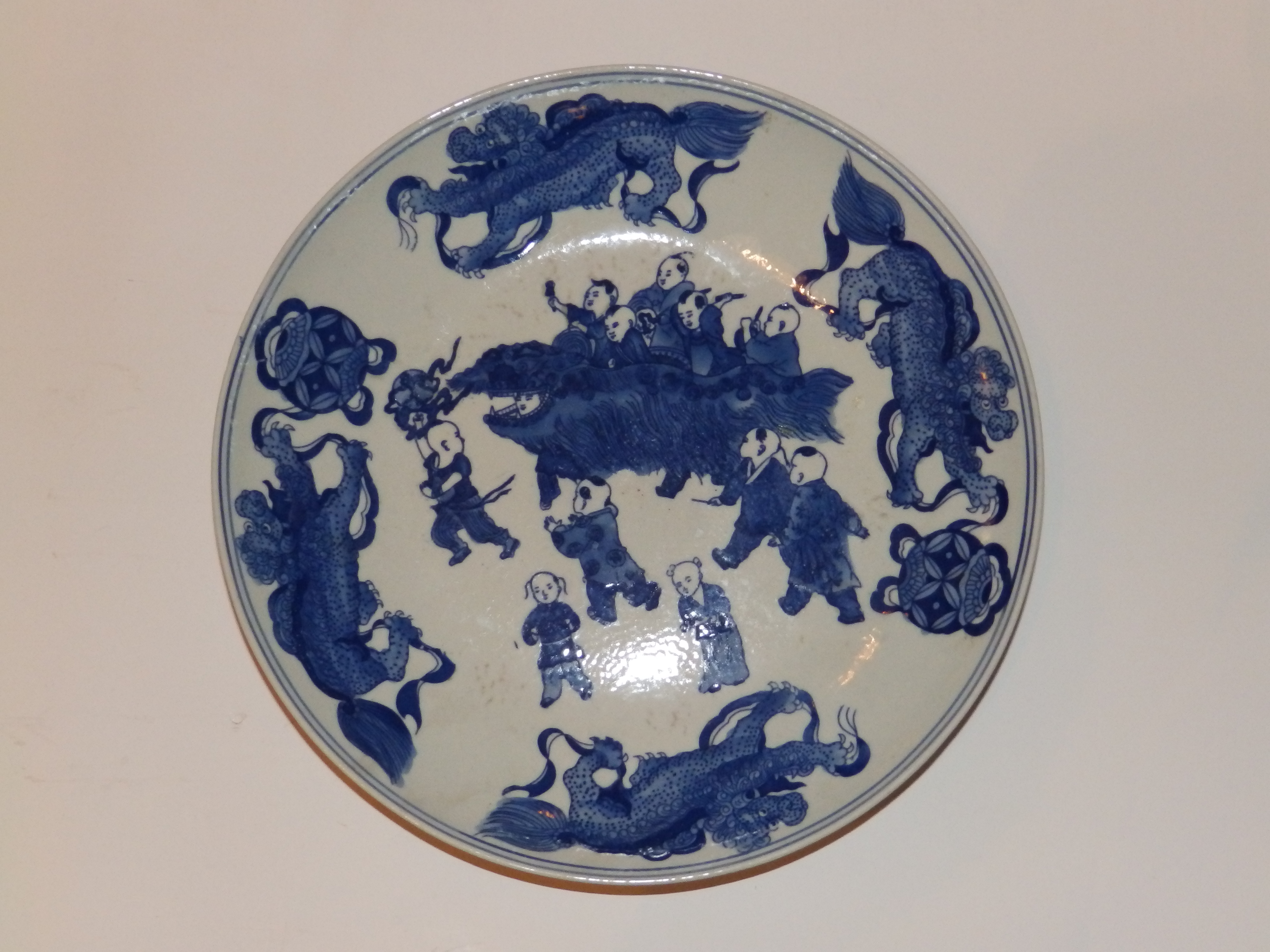 A Chinese blue & white porcelain dish, decorated with boys at play to centre surrounded by four