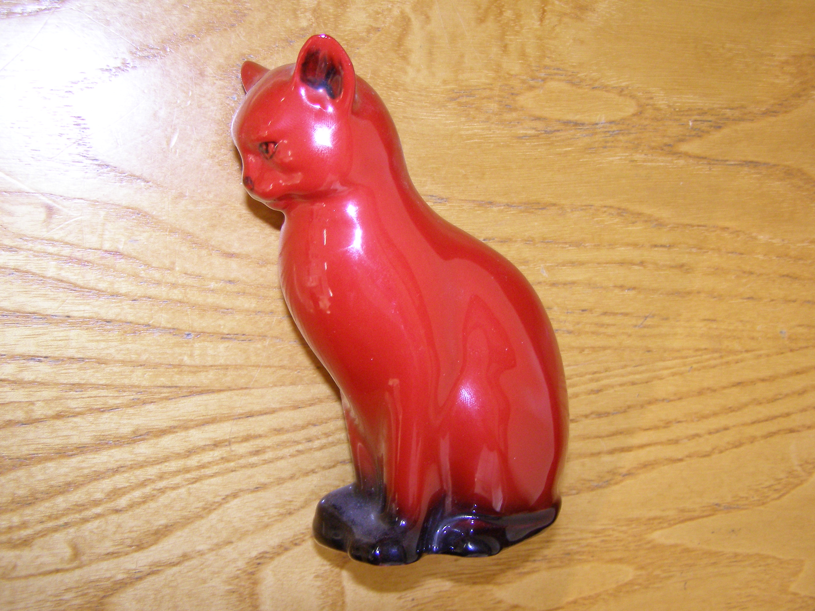 A small Royal Doulton Flambe seated cat
