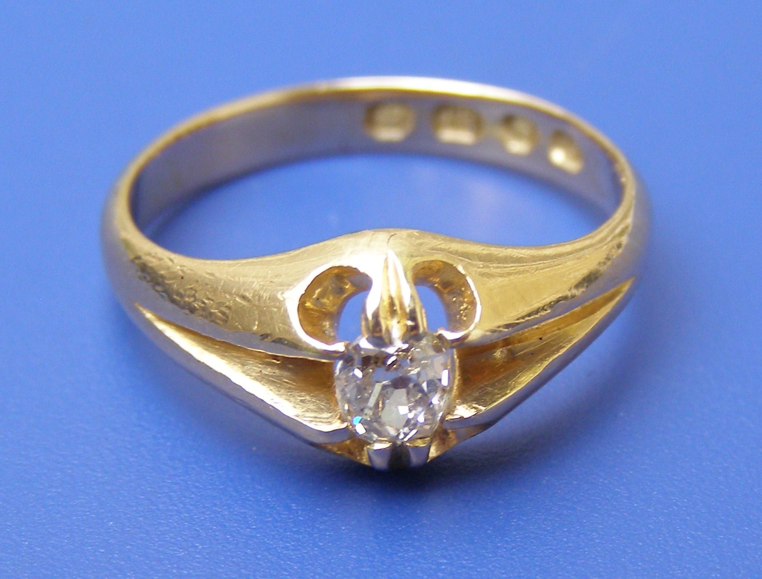 A cushion cut diamond solitaire in heavy 18ct gold setting