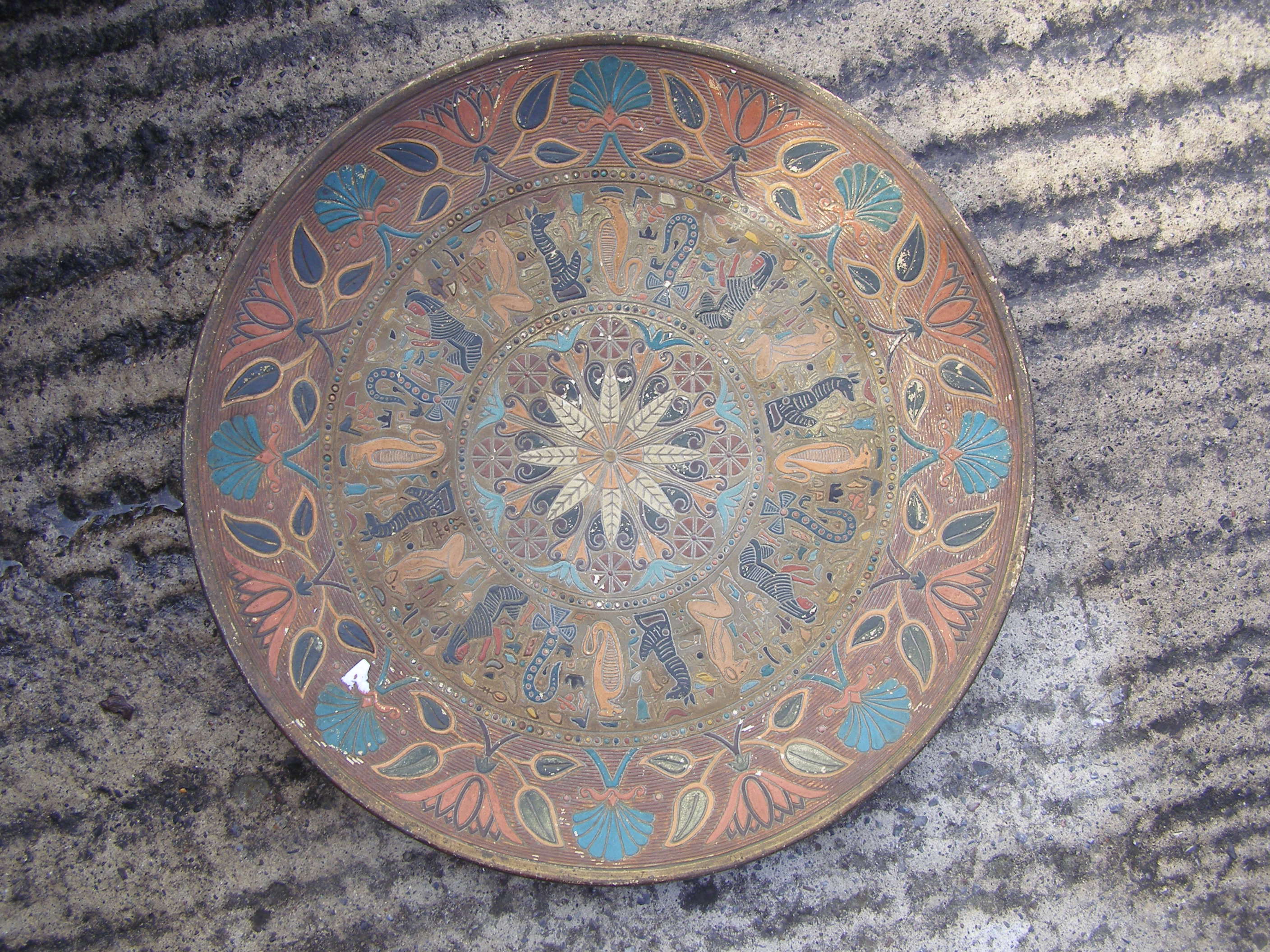 A 19thC earthenware circular wall plaque in Egyptian Revival taste