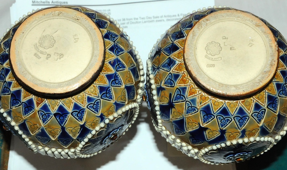 A pair of Doulton Lambeth ewers, decorated in typical colours with impressed marks to base. - Image 2 of 2