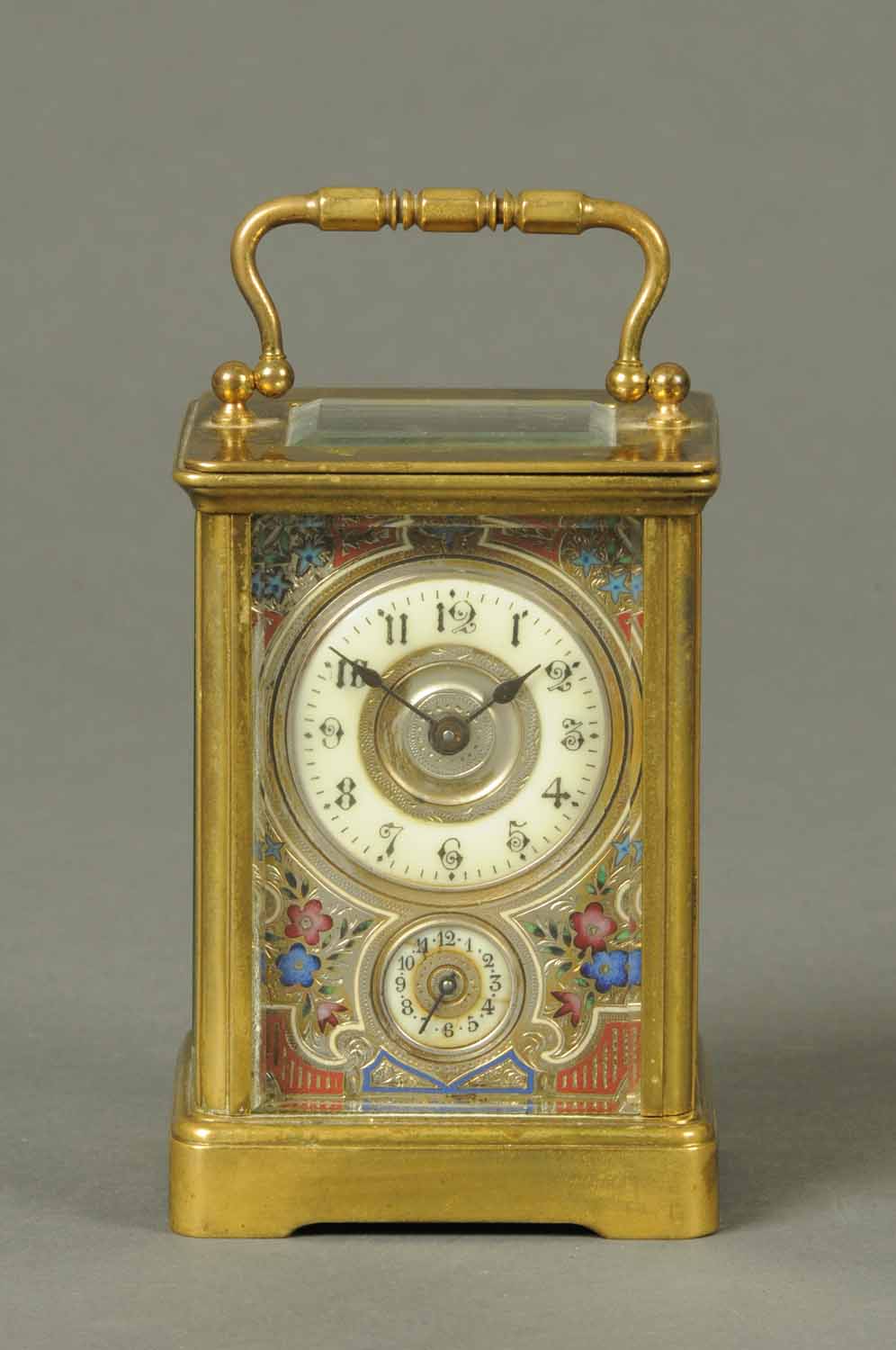 A French brass carriage clock, with alarm, with Champleve enamel dial.  Height excluding carrying