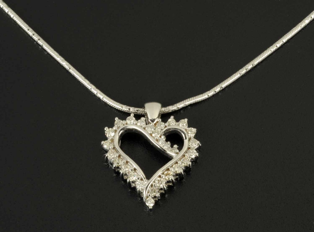 An 18 ct white gold heart pendant, on chain, set with diamonds weighing .52 carats.