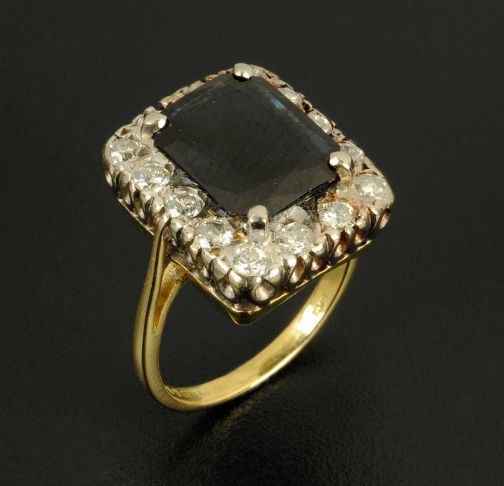 An 18 ct gold sapphire and diamond cluster ring, rectangular setting, London 1978, ring size M.