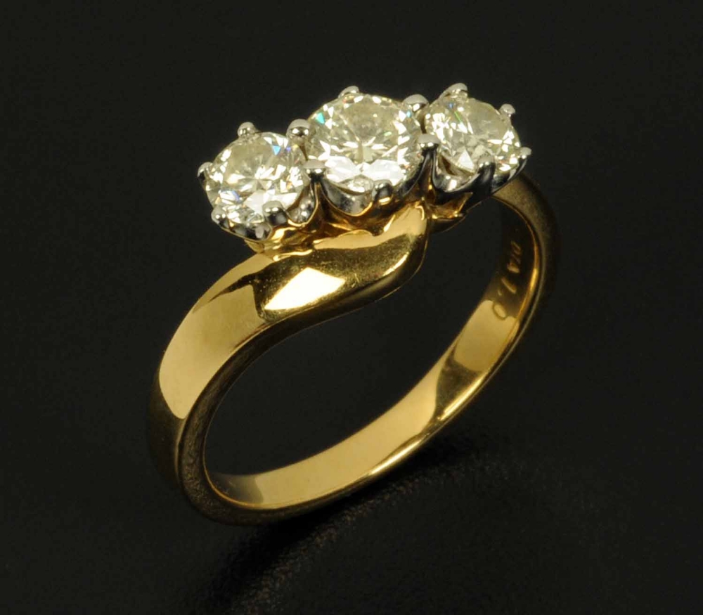 An 18 ct yellow gold three stone diamond ring, diamond weight 1 carat, ring size L/M (see