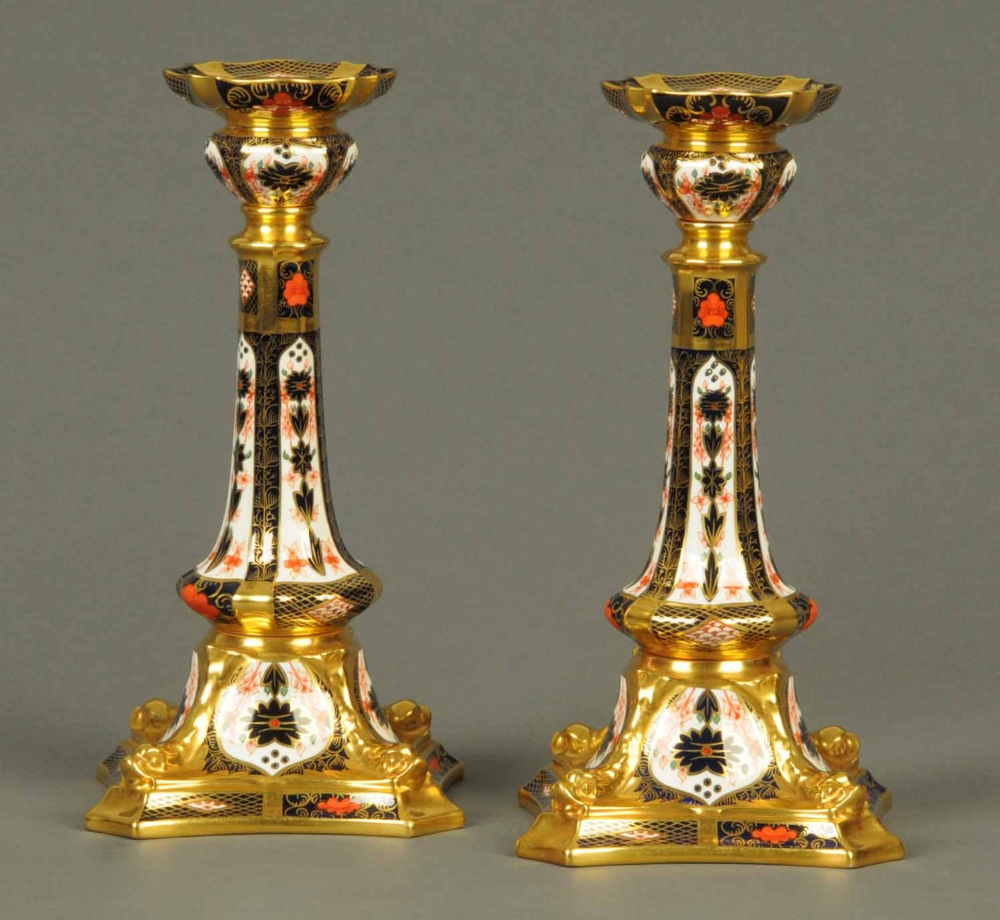 A pair of royal Crown Derby English bone china candlesticks, Model No. 1128, Imari pattern.