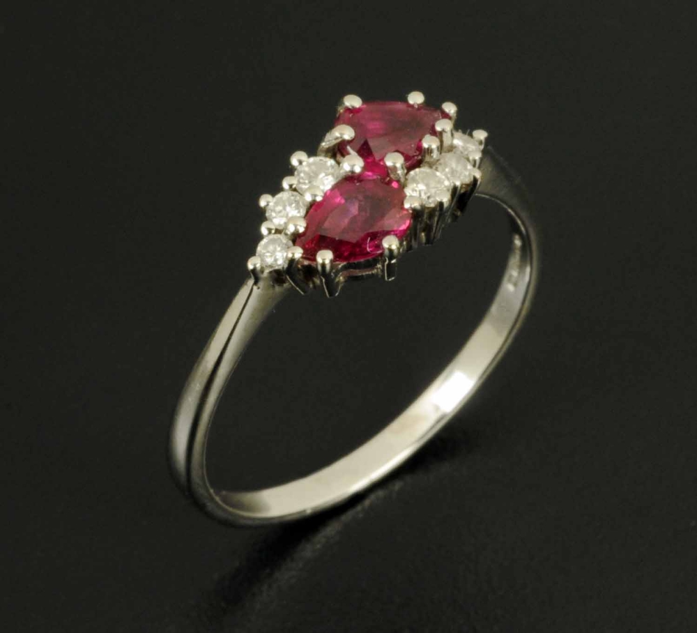 An 18 ct white gold diamond and ruby ring, ring size S/T (see illustration).