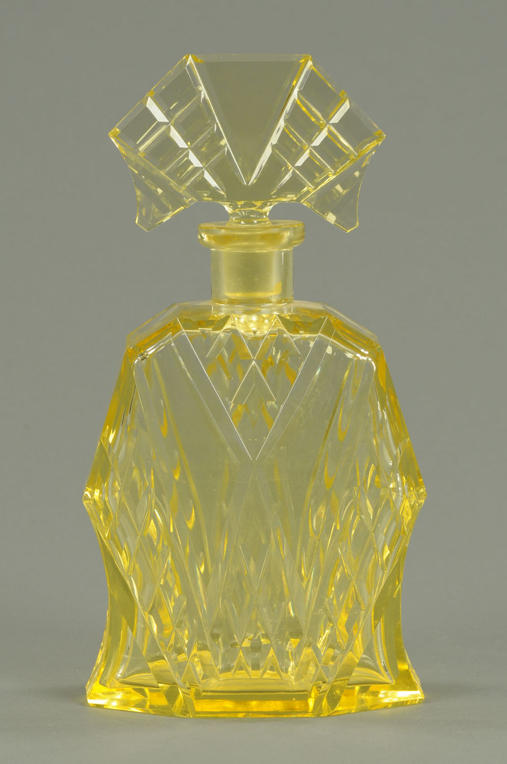 An Art Deco Vaseline glass scent bottle, large faceted form.  Height 11 ins (see illustration).