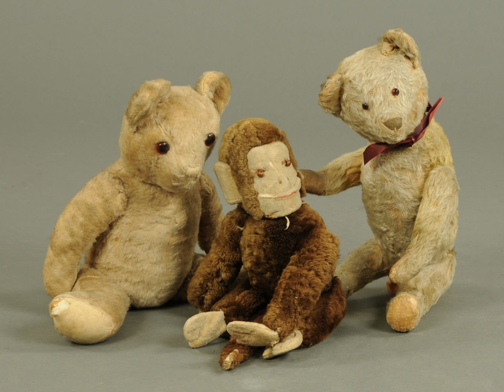 A Schuco monkey soft toy, together with two plush Teddy bears.