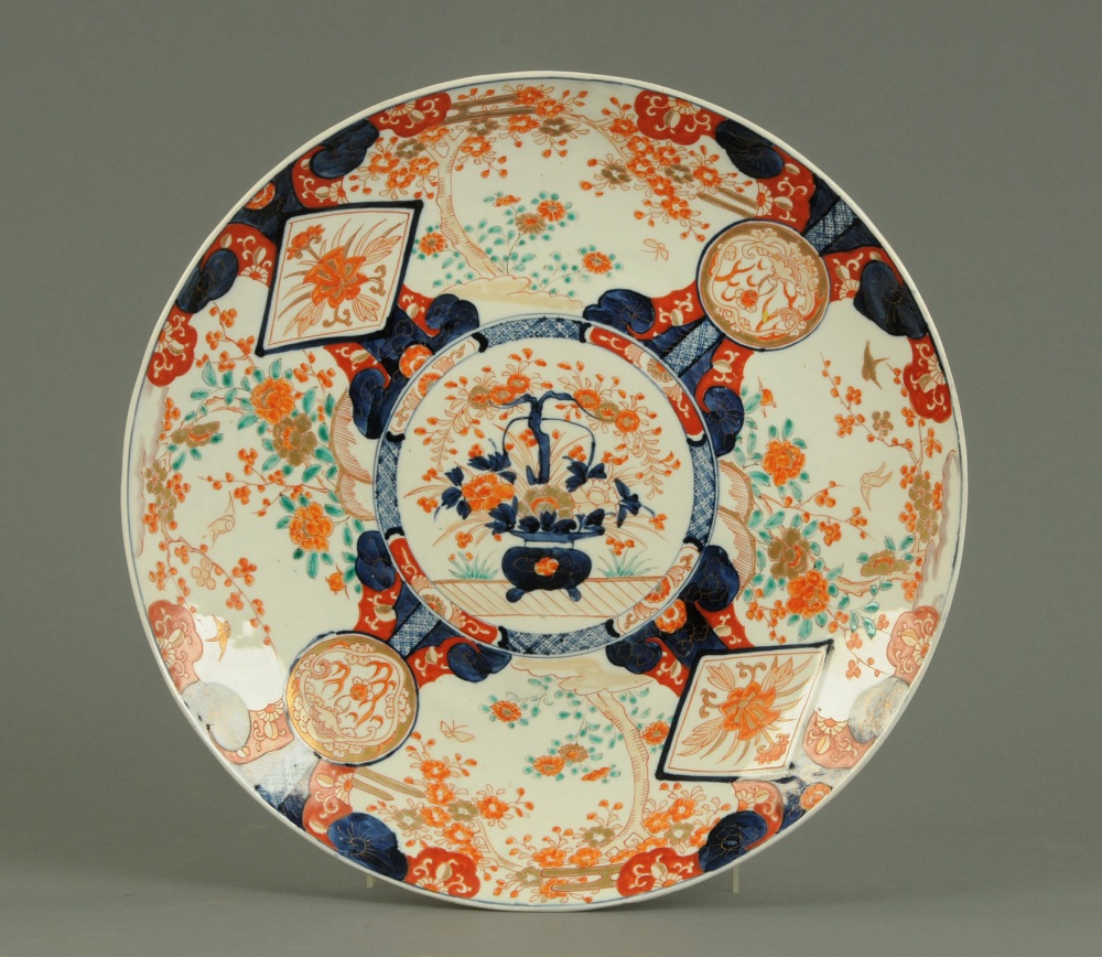 A 19th century Imari plaque, circular, typical Imari colours (see illustration).