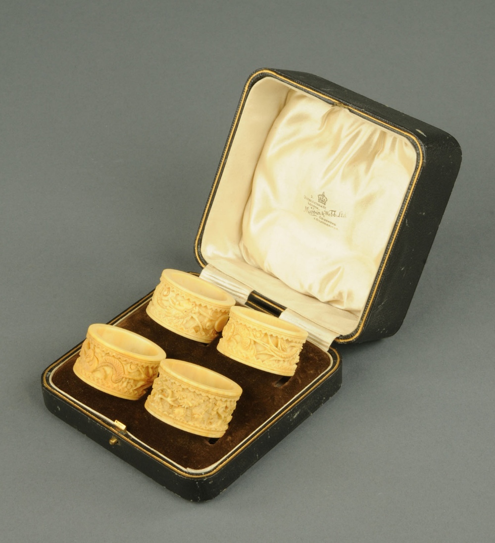 A set of four Cantonese carved ivory serviette rings, in Mappin & Webb case.