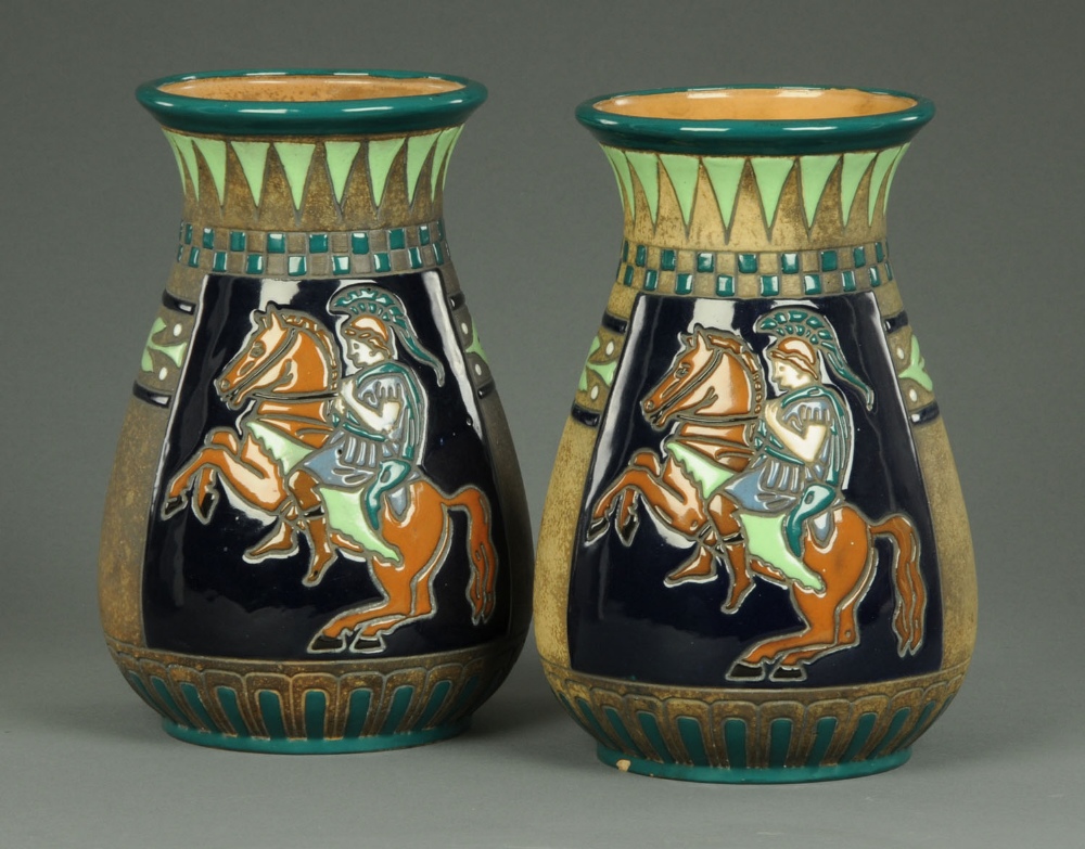 A pair of Amphora vases, decorated with Classical Greek warriors, printed marks to base.  Height