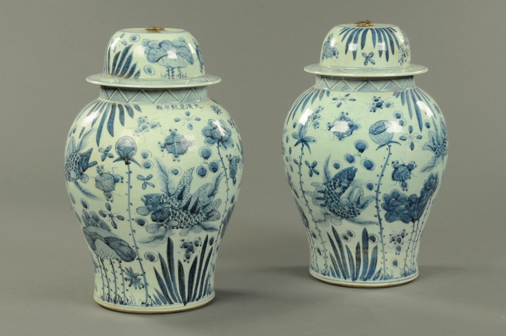 A large pair of Chinese blue and white lidded vases, decorated with carp.  Height 23 ins.