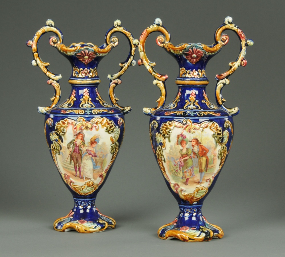 A pair of 19th century Ware vases, twin handled, decorated with printed courting scenes.  Height