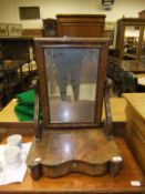 A 19th Century mahogany toilet mirror, the rectangular plate on shaped scroll supports to a shaped