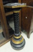 An ebonised and gold painted plant stand with twisted column to turned base