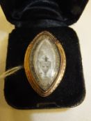 A Georgian gold mounted mourning ring, the ivory plaque depicting urn amongst floral bough, bears