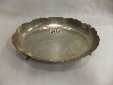 A mid 20th Century silver bonbon dish with shaped edge raised on four feet, bears inscription "Sam