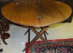 A Victorian oak circular folding coaching table in the manner of Thornton & Hearne