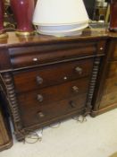 A Victorian mahogany "Scotch" chest of four long drawers with bobbin turned side pilasters on turned