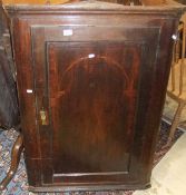 A circa 1800 North Country English oak and cross-banded hanging corner cupboard, the single door