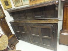 A late 17th Century oak court cupboard with iron hinges, and panelled doors over two further doors