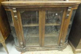 A Victorian walnut display credenza enclosing three shelves and applied moulded decoration