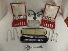 A collection of silver wares to include two cased sets of six silver teaspoons, a Victorian silver