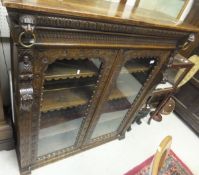 A Victorian oak Gothic Revival bookcase cabinet