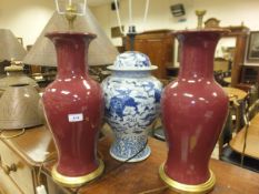 A pair of modern Chinese sang-de-boeuf vase table lamps and a modern Chinese blue and white baluster