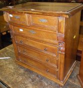 A Continental walnut chest of two short over four long drawers raised on turned feet