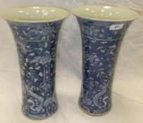 A large pair of Chinese porcelain vases of tapering cylindrical form decorated in underglaze blue