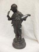 A 19th Century style bronze figure of young boy with quill and pad