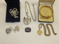 A collection of jewellery to include a white metal locket, a yellow metal mourning locket containing