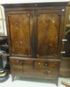 A Victorian mahogany linen press with two cupboard doors over  two short and one long drawer to