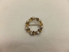 A yellow metal and seven 4 mm split cultured pearl open centre circular brooch