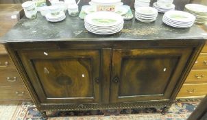 A Continental walnut two door buffet with black painted top, on turned legs