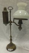 A Victorian brass bodied student's oil lamp with opaque white glass shade