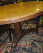 A 19th Century mahogany circular breakfast table, the central pedestal on a shaped base to scroll