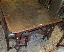 A Victorian mahogany extending dining table, raised on turned and ringed legs to brass caps and