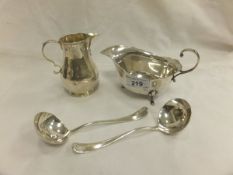 A George V silver sauceboat, together with a George V silver cream jug (by Goldsmiths & Silversmiths