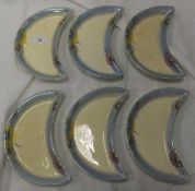 A set of six Clarice Cliff Wilkinson Limited crescent shaped serving dishes with stylised floral