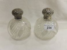 A pair of Edwardian silver mounted cut glass grenade dressing table bottles (probably Henry Hobson &