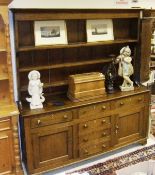 A circa 1900 oak and pine dresser, the three tier graduated plate rack above three drawers over a