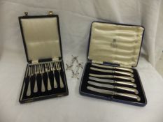 A cased set of six silver handled pistol grip tea knives, together with a cased set of six silver